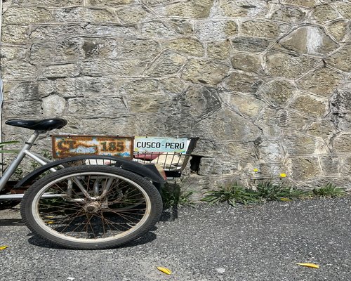 A vintage bicycle parked against an ancient stone wall in Intramuros, Manila.